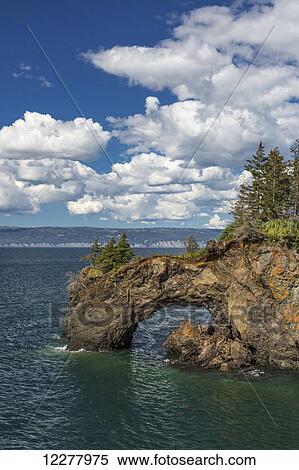 View of a rock arch in Kachemak Bay near Halibut Cove, Southcentral Alaska, Summer. View Large Photo Image Stock Photography - View of a rock arch in Kachemak Bay near Halibut Cove, Southcentral Alaska, Summer.. Fotosearch