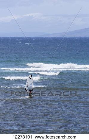 Stock Image - View of a wind surfer playing in the surf; Lahaina, Maui, Hawaii, United States of America. Fotosearch