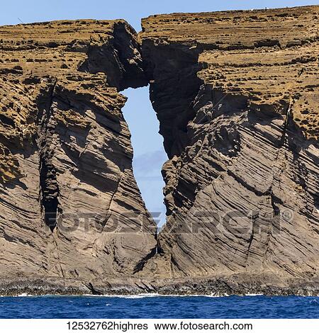 Stock Photograph - View of and through the Keyhole of Lehua Rock off of Ni'ihau (The Forbidden island); Kauai, Hawaii, United States of America. Fotosearch