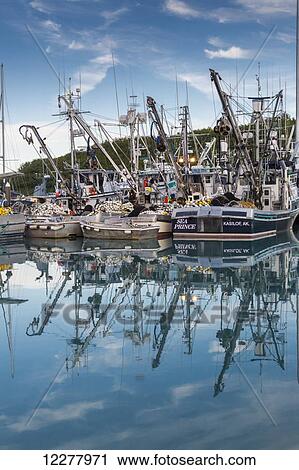 Stock Image - View of seine fishing boats reflecting in the water, Valdez boat harbor, Southcentral Alaska, Summer.. Fotosearch