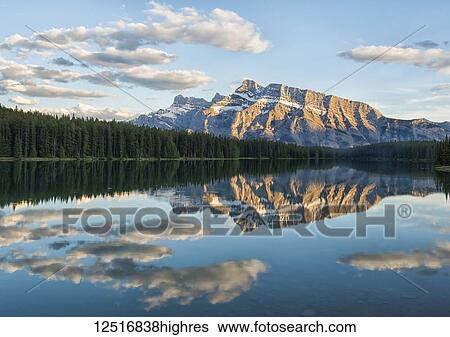 Stock Photograph - View of the back of Mount Rundle reflected in the water of Two Jack Lake, Banff National Park; Banff, Alberta, Canada. Fotosearch