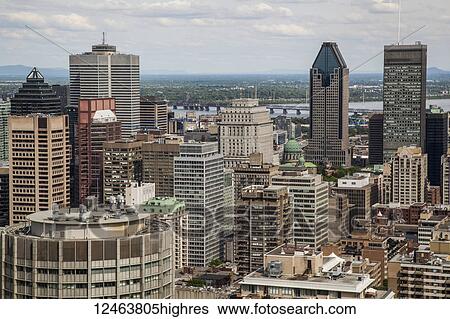 Stock Photograph - View over the city of Montreal with the downtown area, office buildings, condominiums and the river; Montreal, Quebec, Canada. Fotosearch