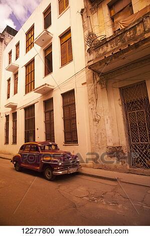 Stock Image - Vintage car parked on a street; Havana, Cuba. Fotosearch