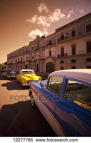 Stock Photography - Vintage cars parked on the street; Havana, Cuba. Fotosearch