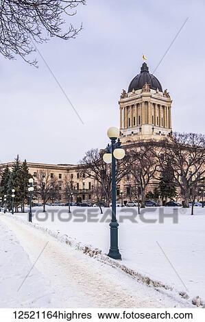 Stock Photograph - Walkway through the Manitoba Legislative Building grounds in winter; Winnipeg, Manitoba, Canada. Fotosearch