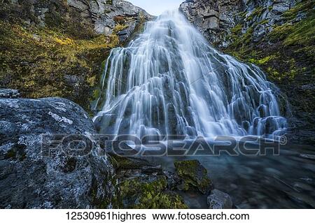 Waterfall along the road; West Fjords, Iceland View Large Photo Image Stock Photograph - Waterfall along the road; West Fjords, Iceland. Fotosearch