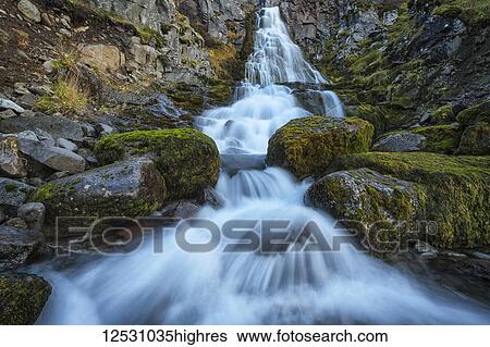 Waterfall along the road; West Fjords, Iceland View Large Photo Image Stock Photograph - Waterfall along the road; West Fjords, Iceland. Fotosearch