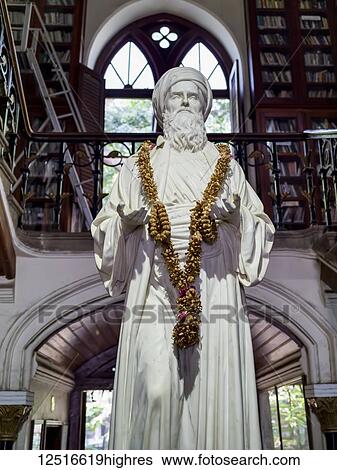 White statue of a male figure with garland draped around it's neck and hands lifted upwards; Mumbai, Maharashtra, India View Large Photo Image Stock Photograph - White statue of a male figure with garland draped around it's neck and hands lifted upwards; Mumbai, Maharashtra, India. Fotosearch