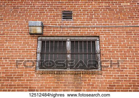 Stock Photograph - Window with iron bars on the outside of a brick building; Connecticut, United States of America. Fotosearch