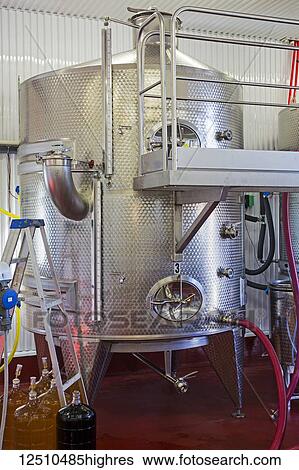 Stock Photograph - Wine holding and fermenting tanks; Shefford, Quebec, Canada. Fotosearch