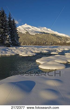 Stock Photo - Wintertime Scenic View Of Snowcovered Meadow And Mountains In The Background In The Tongass National Forest In Southeast, Alaska. Fotosearch