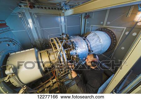 Worker working on an electrical power plant, gas turbine generator and drive shaft, Prudhoe Bay, Arctic Alaska, USA, Summer View Large Photo Image Stock Photograph - Worker working on an electrical power plant, gas turbine generator and drive shaft, Prudhoe Bay, Arctic Alaska, USA, Summer. Fotosearch