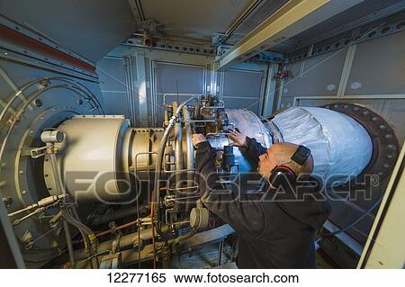 Worker working on an electrical power plant, gas turbine generator and drive shaft, Prudhoe Bay, Arctic Alaska, USA, Summer View Large Photo Image Stock Photography - Worker working on an electrical power plant, gas turbine generator and drive shaft, Prudhoe Bay, Arctic Alaska, USA, Summer. Fotosearch