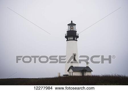 Yaquina Head Lighthouse is surrounded by fog; Newport, Oregon, United States of America View Large Photo Image Picture - Yaquina Head Lighthouse is surrounded by fog; Newport, Oregon, United States of America. Fotosearch