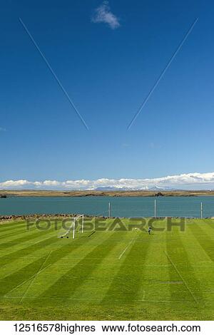 Young boy playing football on pitch beside the sea; Borganes, Iceland View Large Photo Image Stock Photograph - Young boy playing football on pitch beside the sea; Borganes, Iceland. Fotosearch