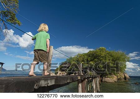 Young boy walking along narrow wooden bridge to mini island off Mumbo Island, Lake Malawi; Malawi View Large Photo Image Stock Image - Young boy walking along narrow wooden bridge to mini island off Mumbo Island, Lake Malawi; Malawi. Fotosearch