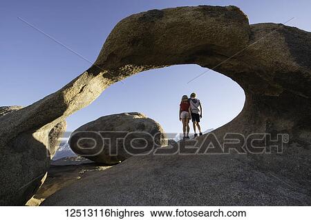 Young children standing under a natural rock arch, Alabama Hills; California, United States of America View Large Photo Image Stock Photograph - Young children standing under a natural rock arch, Alabama Hills; California, United States of America. Fotosearch
