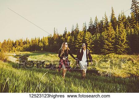 Young couple walking together beside a creek in a city park; Edmonton, Alberta, Canada View Large Photo Image Stock Photograph - Young couple walking together beside a creek in a city park; Edmonton, Alberta, Canada. Fotosearch