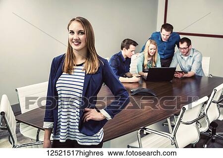 Young millennial business professionals working together in a conference room in a high tech modern business; Sherwood Park, Alberta, Canada View Large Photo Image Stock Photograph - Young millennial business professionals working together in a conference room in a high tech modern business; Sherwood Park, Alberta, Canada. Fotosearch