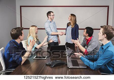 Young millennial business professionals working together in a conference room in a place of business and praising the efforts of one of their peers; Sherwood Park, Alberta, Canada View Large Photo Image Stock Photograph - Young millennial business professionals working together in a conference room in a place of business and praising the efforts of one of their peers; Sherwood Park, Alberta, Canada. Fotosearch