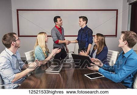 Young millennial business professionals working together in a conference room in a place of business and praising the efforts of one of their peers; Sherwood Park, Alberta, Canada View Large Photo Image Stock Photograph - Young millennial business professionals working together in a conference room in a place of business and praising the efforts of one of their peers; Sherwood Park, Alberta, Canada. Fotosearch