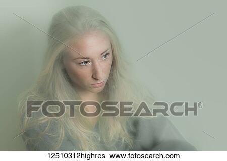 Young woman with long blond hair looking down with a hazy effect; Connecticut, United States of America View Large Photo Image Stock Photograph - Young woman with long blond hair looking down with a hazy effect; Connecticut, United States of America. Fotosearch