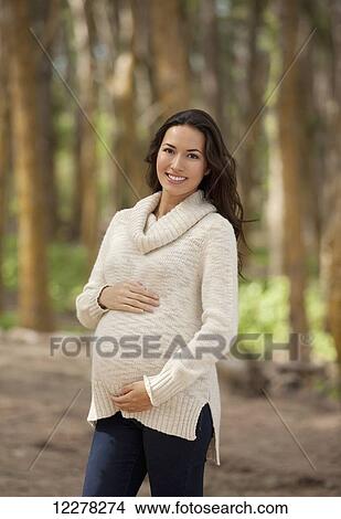 A pregnant woman walking in the woods; Hawaii, United States of America View Large Photo Image Picture - A pregnant woman walking in the woods; Hawaii, United States of America. Fotosearch