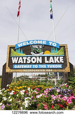 A Welcome to Watson Lake sign with flags in the background, Yukon Territory, Canada, Summer View Large Photo Image Stock Photograph - A Welcome to Watson Lake sign with flags in the background, Yukon Territory, Canada, Summer. Fotosearch