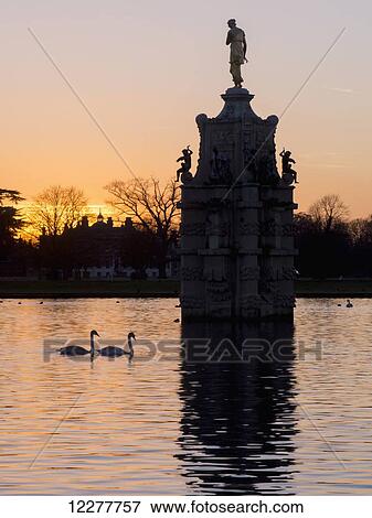 Stock Photo - Bushey park and Arethusa statue at sunset; London, England. Fotosearch