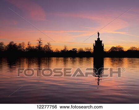Stock Photograph - Bushey park and fountain at sunset; London, England. Fotosearch