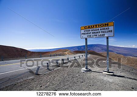 Stock Photograph - Caution sign along roadside towards Mauna Kea; Island of Hawaii, Hawaii, United States of America. Fotosearch