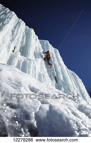 Stock Photograph - Climbing an ice wall; Saint-Donat, Quebec, Canada. Fotosearch