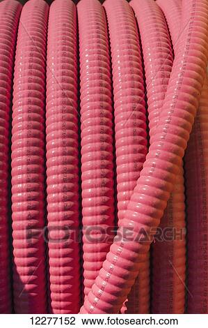 Stock Image - Close up of a red ribbed hose at an electrical power plant, Prudhoe Bay, Arctic Alaska, USA, Summer. Fotosearch