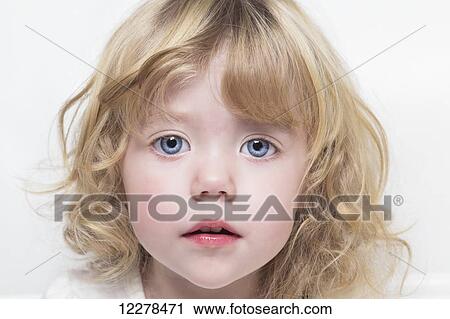 Close up of a toddler with beautiful big blue eyes and blond curly hair; Spruce Grove, Alberta, Canada View Large Photo Image Stock Image - Close up of a toddler with beautiful big blue eyes and blond curly hair; Spruce Grove, Alberta, Canada. Fotosearch