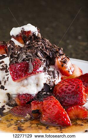 Stock Photo - Close up of strawberry short cake with whipping cream and chocolate shavings; Calgary, Alberta, Canada. Fotosearch