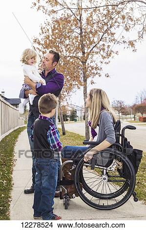 Disabled young mother spending quality time with her family outdoors; Spruce Grove, Alberta, Canada View Large Photo Image Picture - Disabled young mother spending quality time with her family outdoors; Spruce Grove, Alberta, Canada. Fotosearch