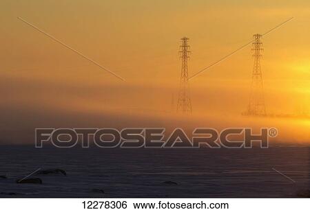 Electricity pylons in the fog at sunrise on the shore of the St. Lawrence river; Les Cedres, Quebec, Canada View Large Photo Image Stock Photograph - Electricity pylons in the fog at sunrise on the shore of the St. Lawrence river; Les Cedres, Quebec, Canada. Fotosearch