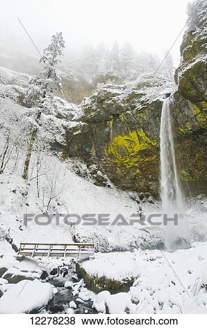 Stock Photo - Elowah Falls and fresh snow in winter, Columbia River Gorge; Oregon, United States of America. Fotosearch