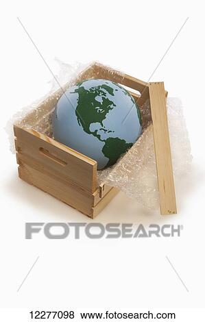 Stock Photo - Globe in shipping crate; Edmonton, Alberta, Canada. Fotosearch