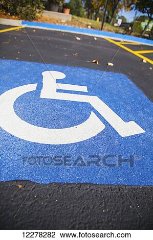 Handicap symbol painted in a parking lot stall; Wheaton, Illinois, United States of America View Large Photo Image Stock Image - Handicap symbol painted in a parking lot stall; Wheaton, Illinois, United States of America. Fotosearch