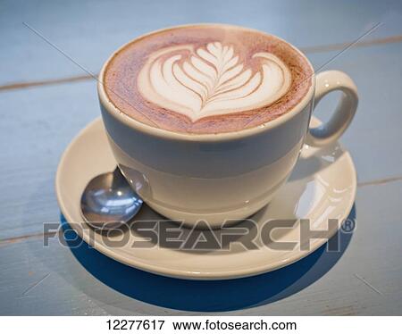 Hot drink with leaf design in milk on surface; Vancouver, British Columbia, Canada View Large Photo Image Stock Photo - Hot drink with leaf design in milk on surface; Vancouver, British Columbia, Canada. Fotosearch
