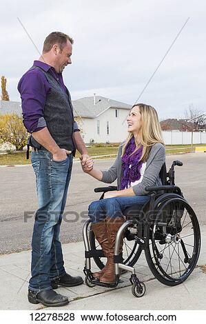 Husband and wife with disability spending time together outdoors; Spruce Grove, Alberta, Canada View Large Photo Image Stock Photo - Husband and wife with disability spending time together outdoors; Spruce Grove, Alberta, Canada. Fotosearch