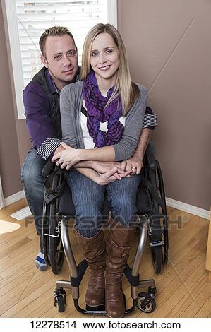 Husband posing with his disabled wife in their home; Spruce Grove, Alberta, Canada View Large Photo Image Picture - Husband posing with his disabled wife in their home; Spruce Grove, Alberta, Canada. Fotosearch