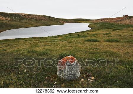 Stock Image - Lone rock, shore of a bay, near Cambridge Bay; Nunavut, Canada. Fotosearch