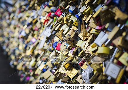 Stock Photo - Padlocks with love messages line a bridge; Paris, France. Fotosearch