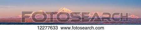 Stock Image - Panoramic view of the Wrangell Mountains above the Copper River Valley at sunset, Southcentral Alaska, Winter. Fotosearch
