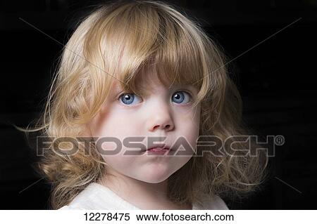 Portrait of a beautiful young girl with huge blue eyes and ...