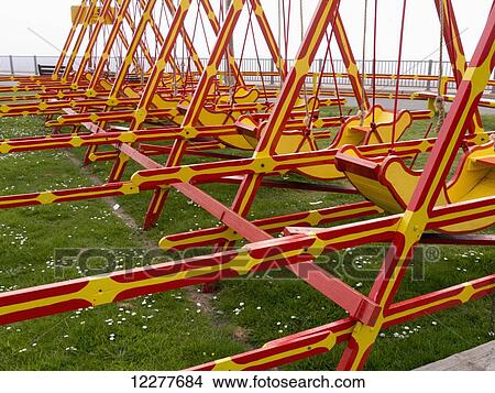 Red and white swings at an amusement park; England View Large Photo Image Picture - Red and white swings at an amusement park; England. Fotosearch