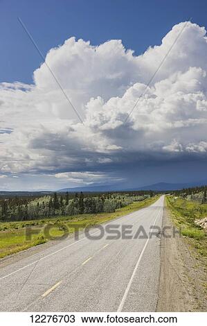 Scenic view of the Alaska Highway near Whitehorse with rain clouds in the distance, Yukon Territory, Canada, Summer View Large Photo Image Stock Image - Scenic view of the Alaska Highway near Whitehorse with rain clouds in the distance, Yukon Territory, Canada, Summer. Fotosearch