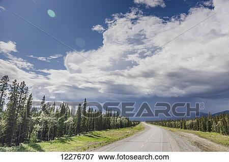 Scenic view of the Alaska Highway near Whitehorse with rain clouds in the distance, Yukon Territory, Canada, Summer View Large Photo Image Stock Photo - Scenic view of the Alaska Highway near Whitehorse with rain clouds in the distance, Yukon Territory, Canada, Summer. Fotosearch